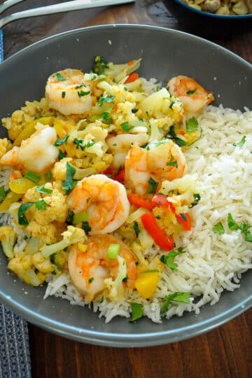 shrimp and cauliflower in a gray bowl with rice