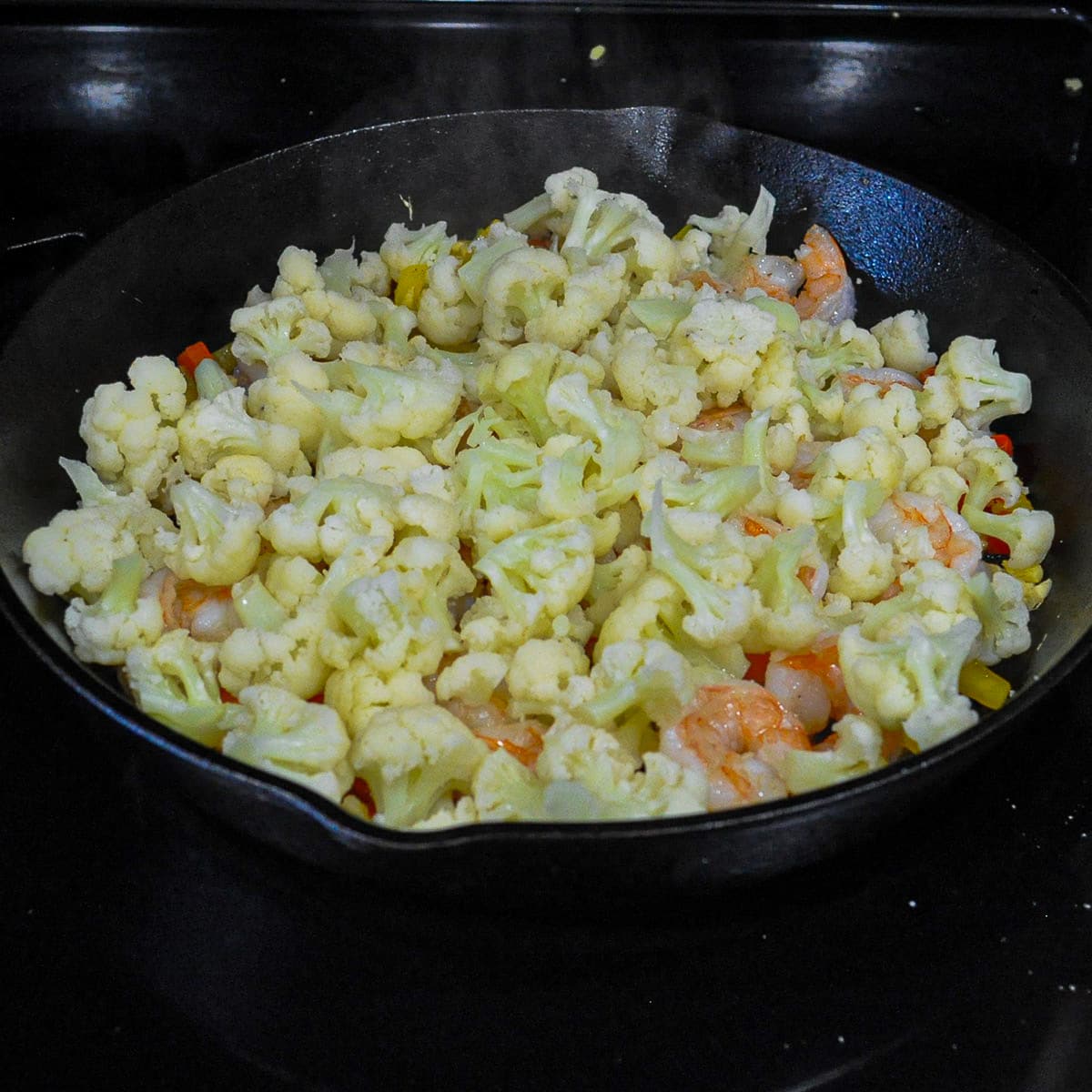 shrimp with cauliflower in a cast iron skillet