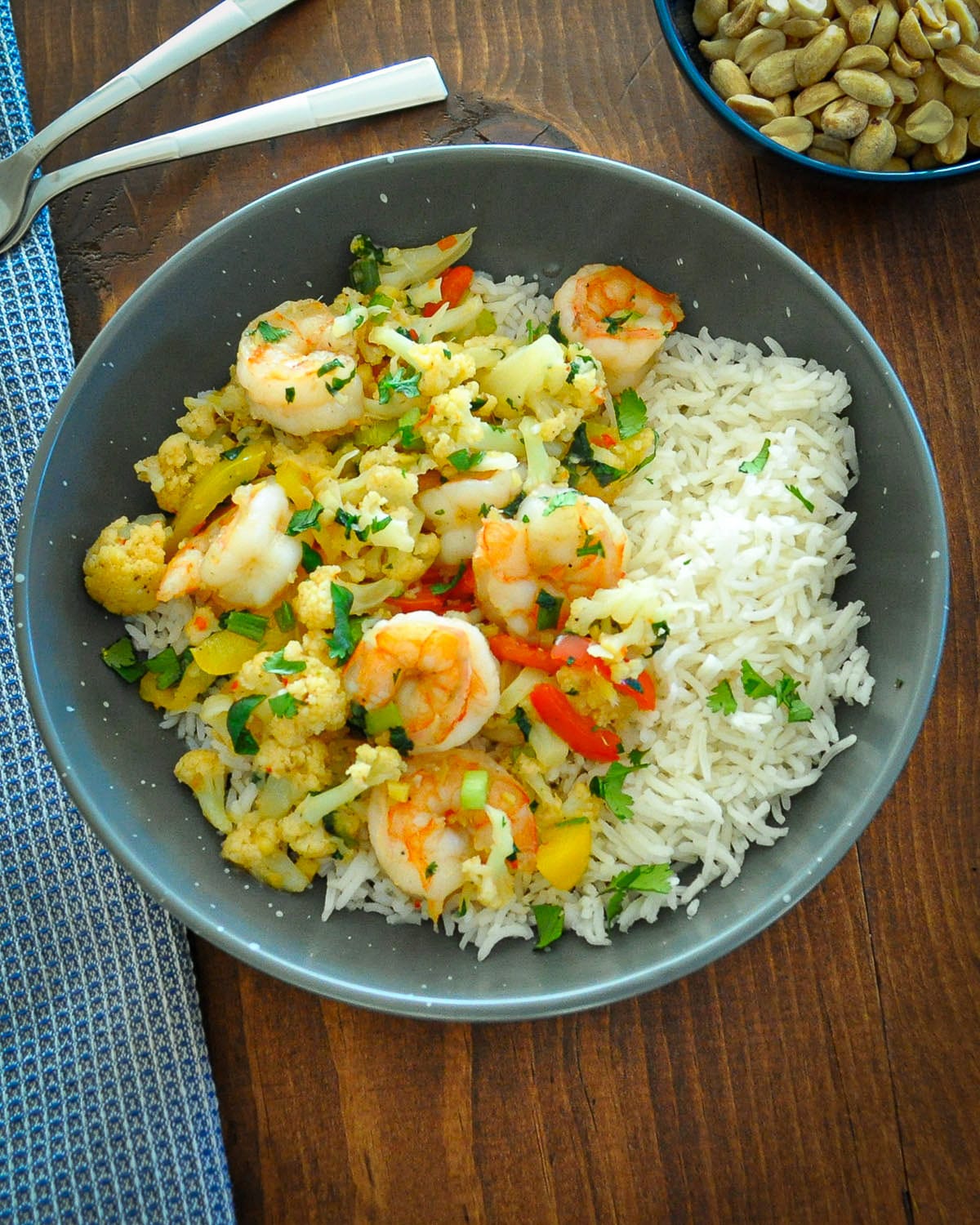 shrimp and cauliflower in a gray bowl with rice