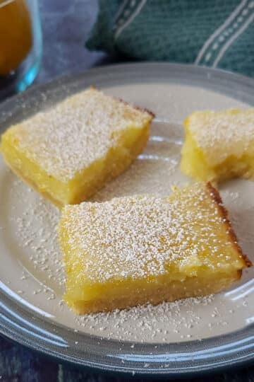 3 lemon bar cookies sitting on a plate