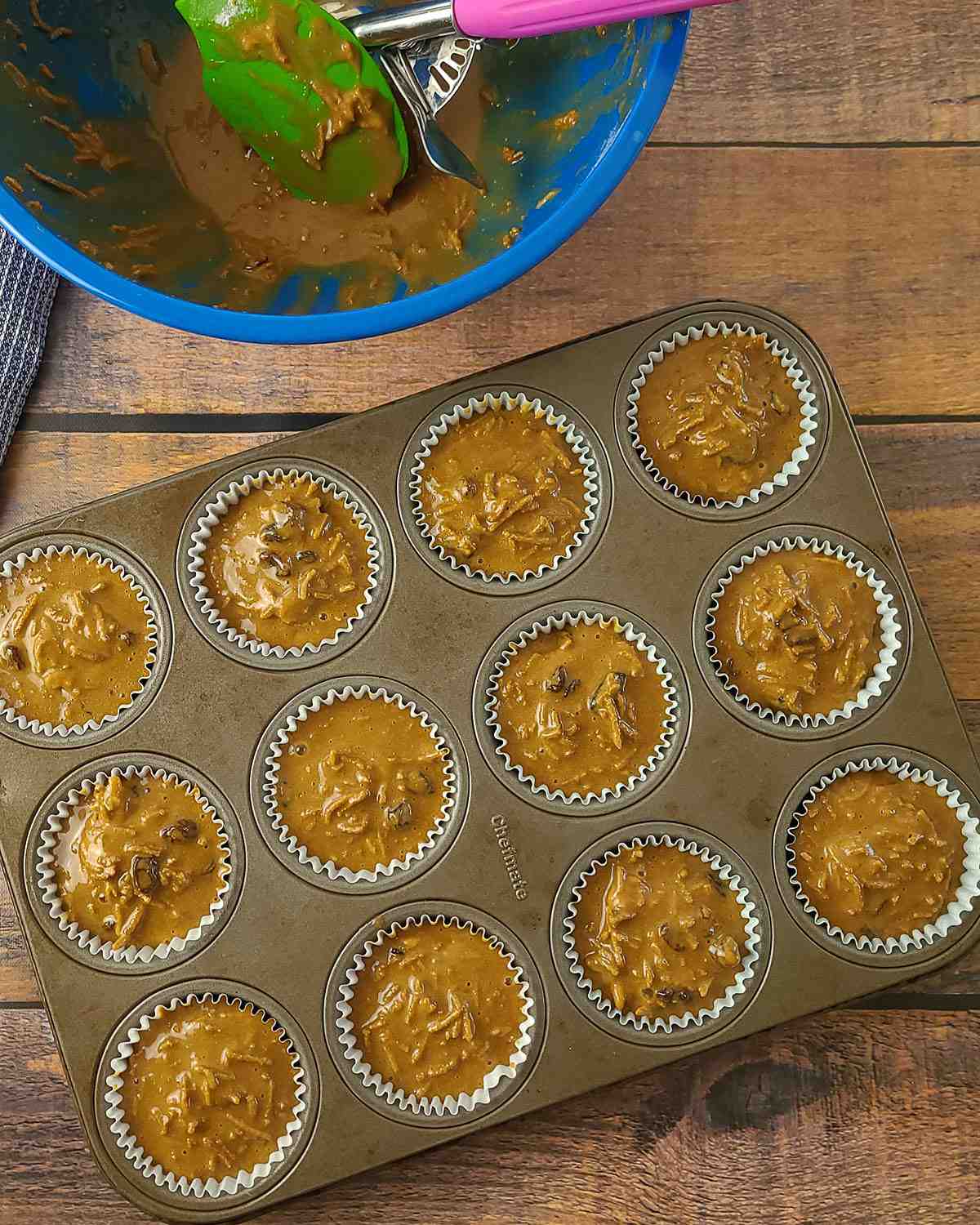 filling a muffin pan with bran muffin batter