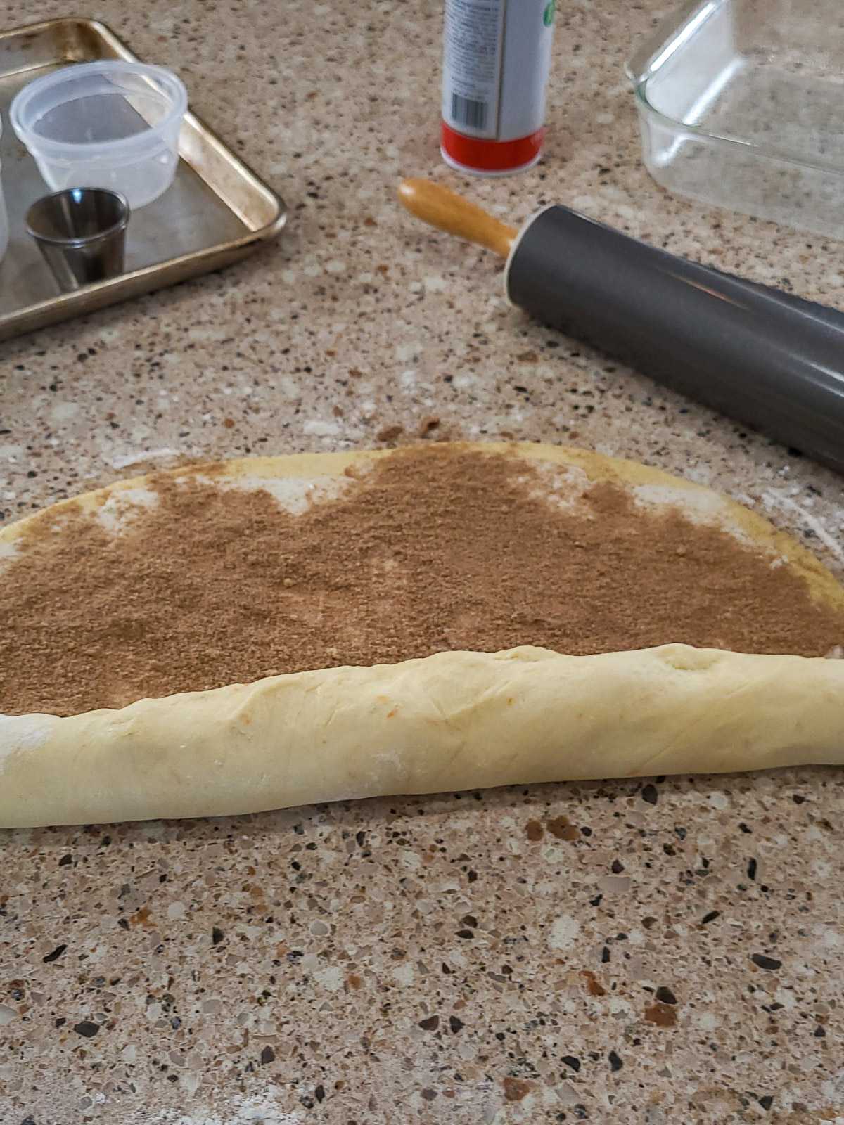 rolling up cinnamon roll dough