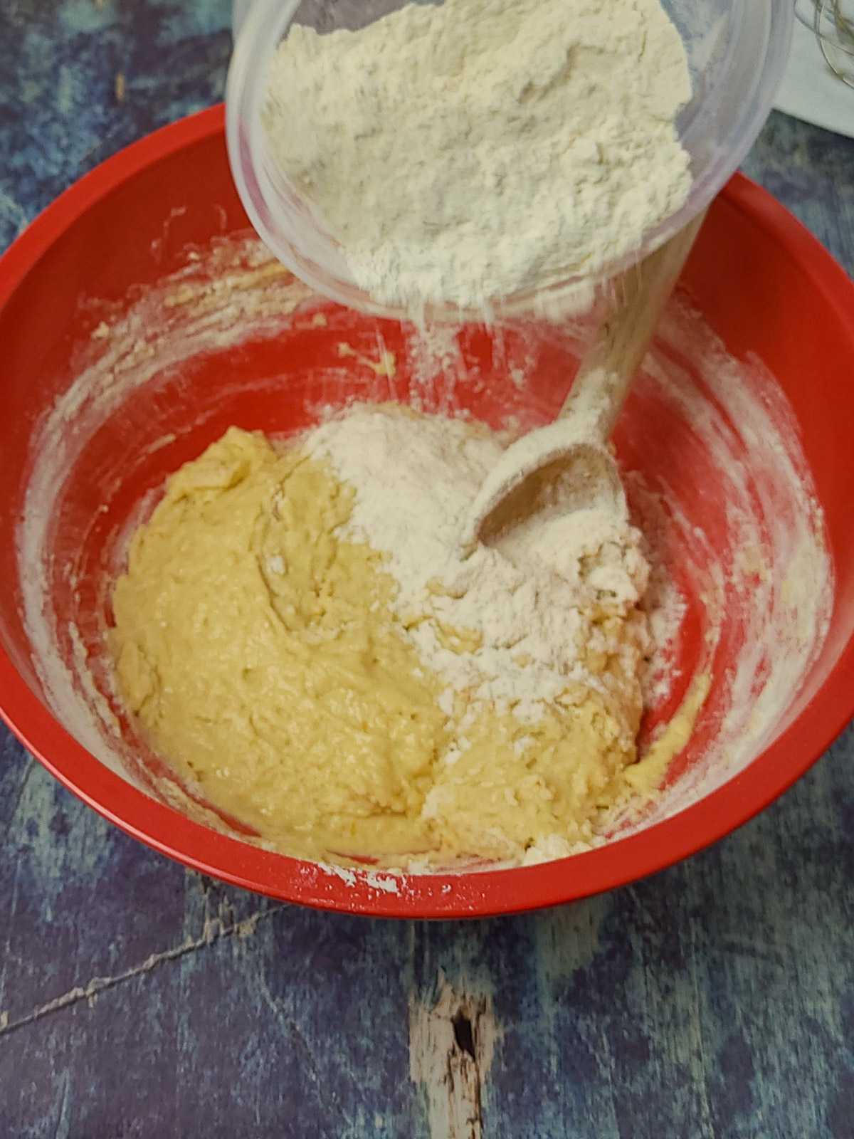 flour being mixed in cinnamon roll dough