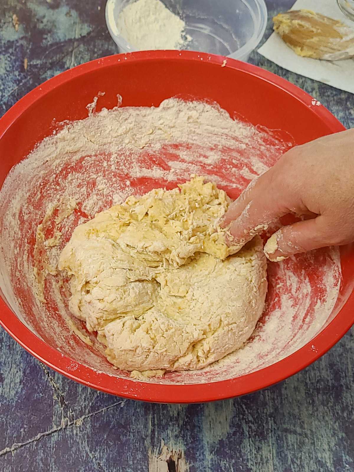 flour being mixed in cinnamon roll dough