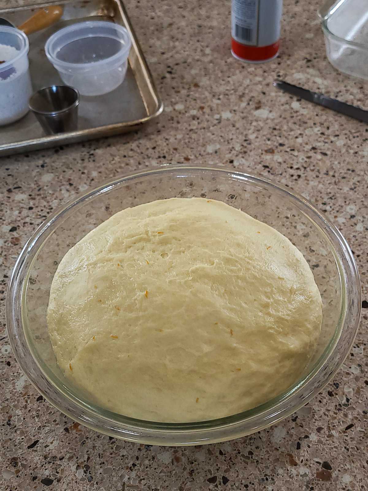 raised cinnamon roll dough in a bowl