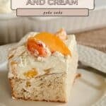 A slice of Peaches and Cream Poke Cake on a white plate with a fork, topped with peach slices and cream.