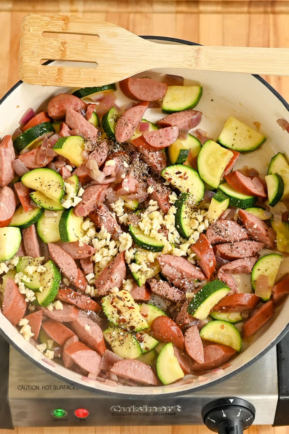 Pasta with Veggies & Smoked Sausage comes alive as sliced sausage, zucchini, and chopped garlic sizzle in a skillet with pepper and seasonings.
