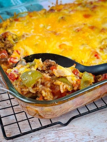 bell pepper casserole being served from a casserole dish with a black spoon