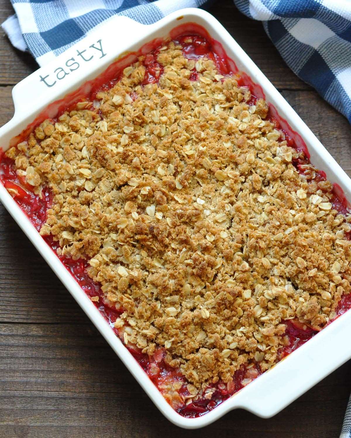 a baking dish with cooked plums topped with oatmeal crumble topping