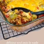A glass dish of Simple Bell Pepper Casserole, loaded with cheesy goodness and vibrant bell peppers, with a serving spoon lifting a generous portion.
