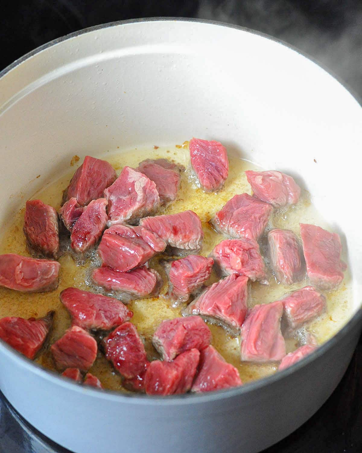 stew meat browning in a dutch oven