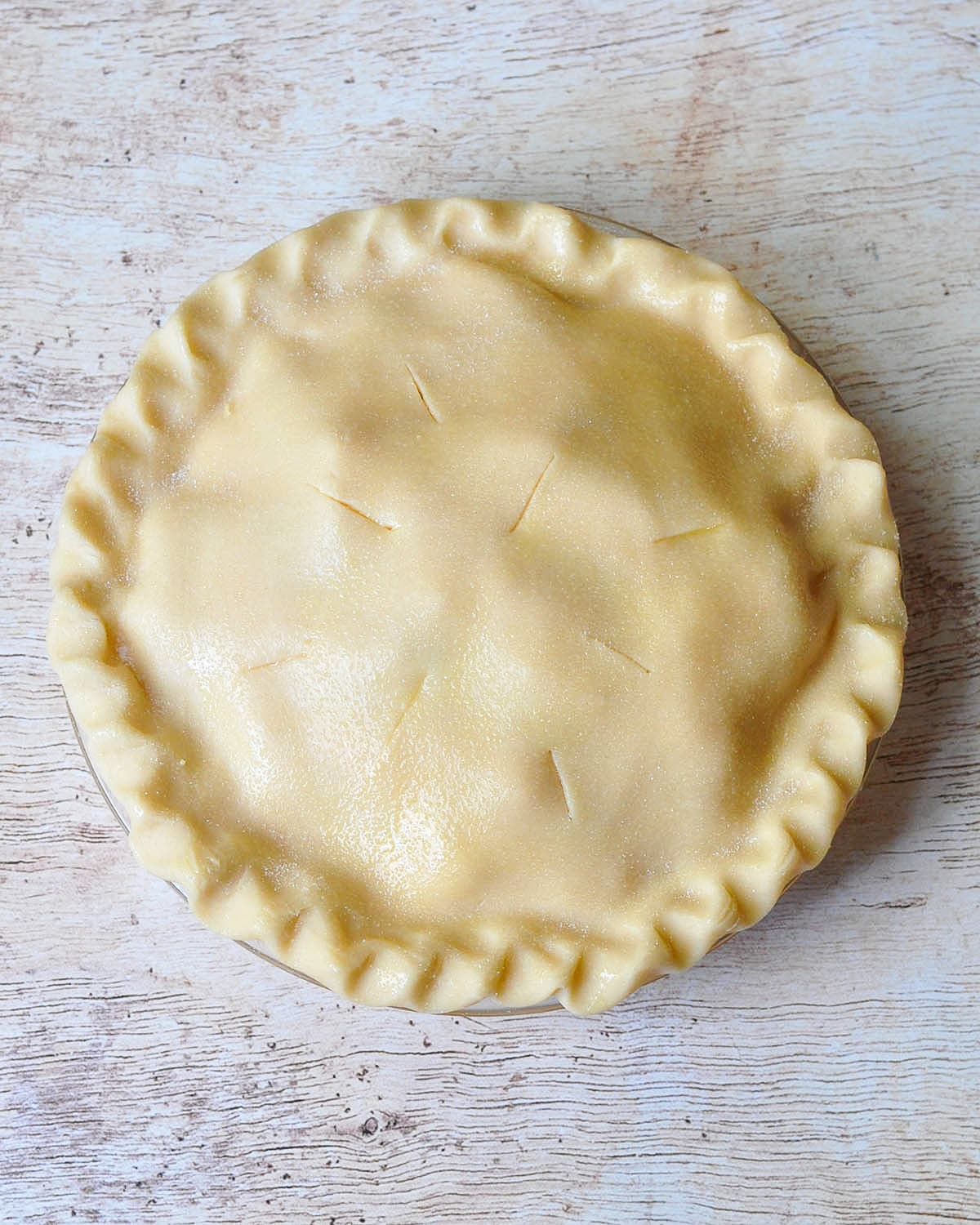 an unbaked double crust pie ready to go into the oven