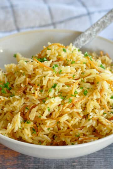 rice with pasta in a gray bowl next to a towel