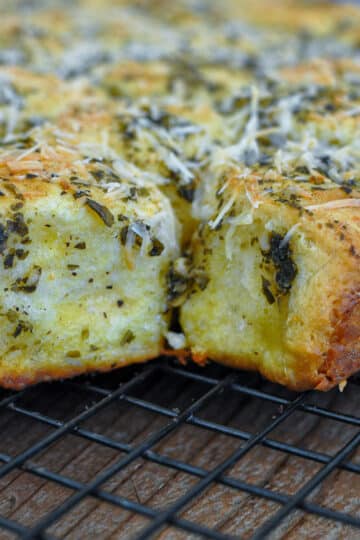 pesto and parmesan rolls on a wire rack.