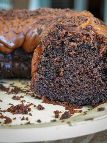 a chocolate bundt cake with several slices removed.