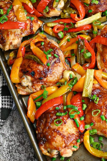 Baked sweet and sour chicken thighs on a sheet pan.