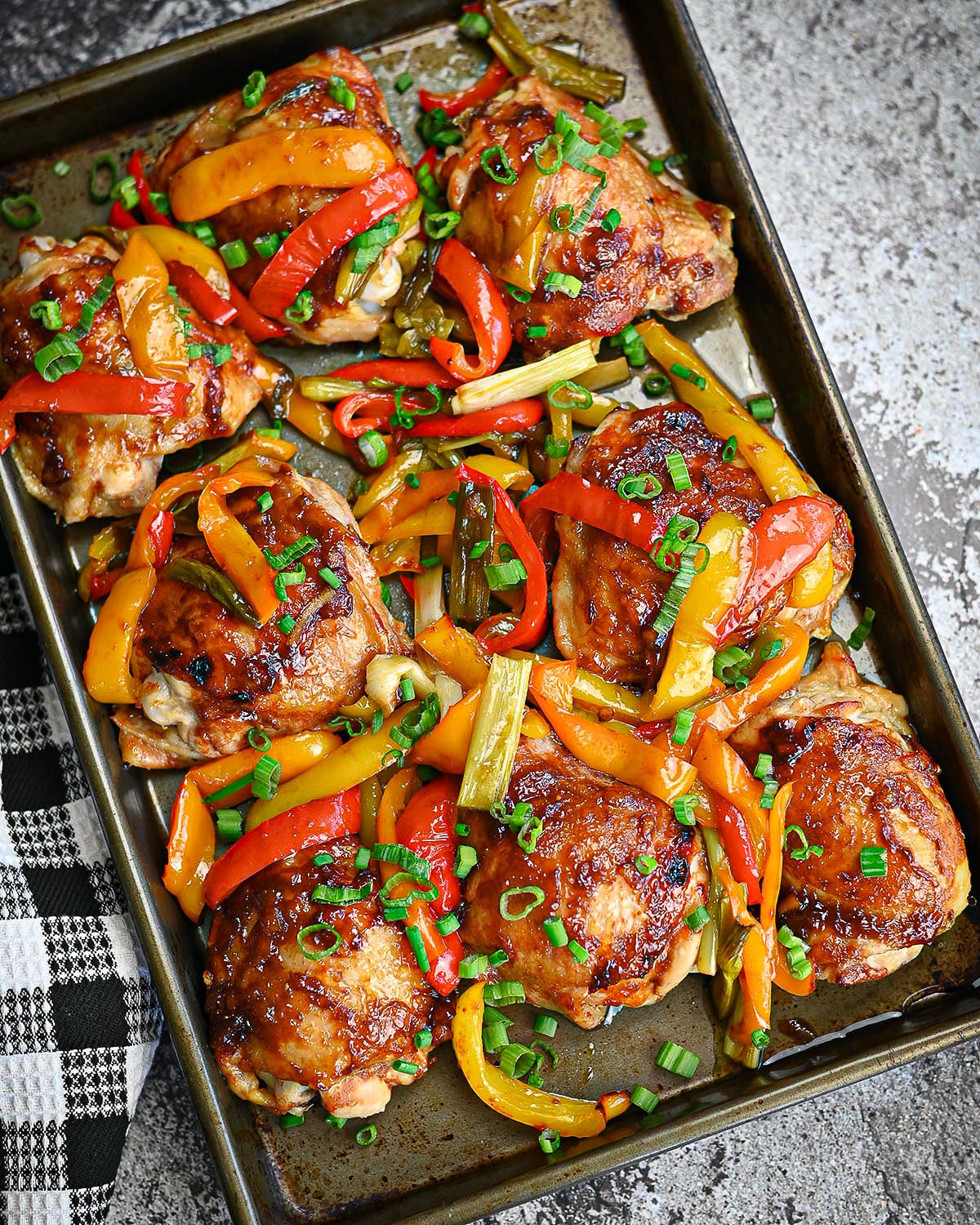 Baked sweet and sour chicken thighs on a sheet pan. 