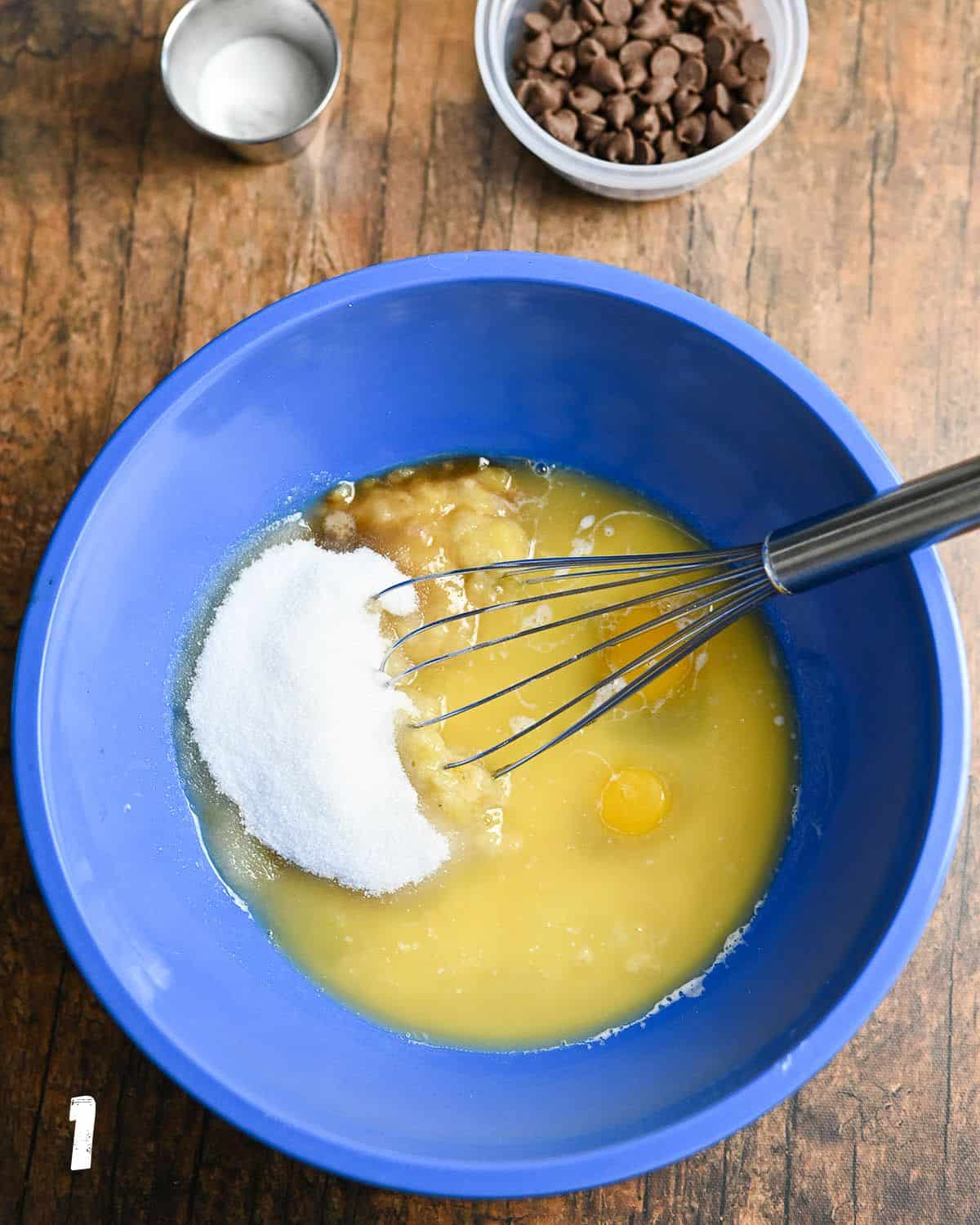 Liquid ingredients needed to make muffins in a blue mixing bowl.