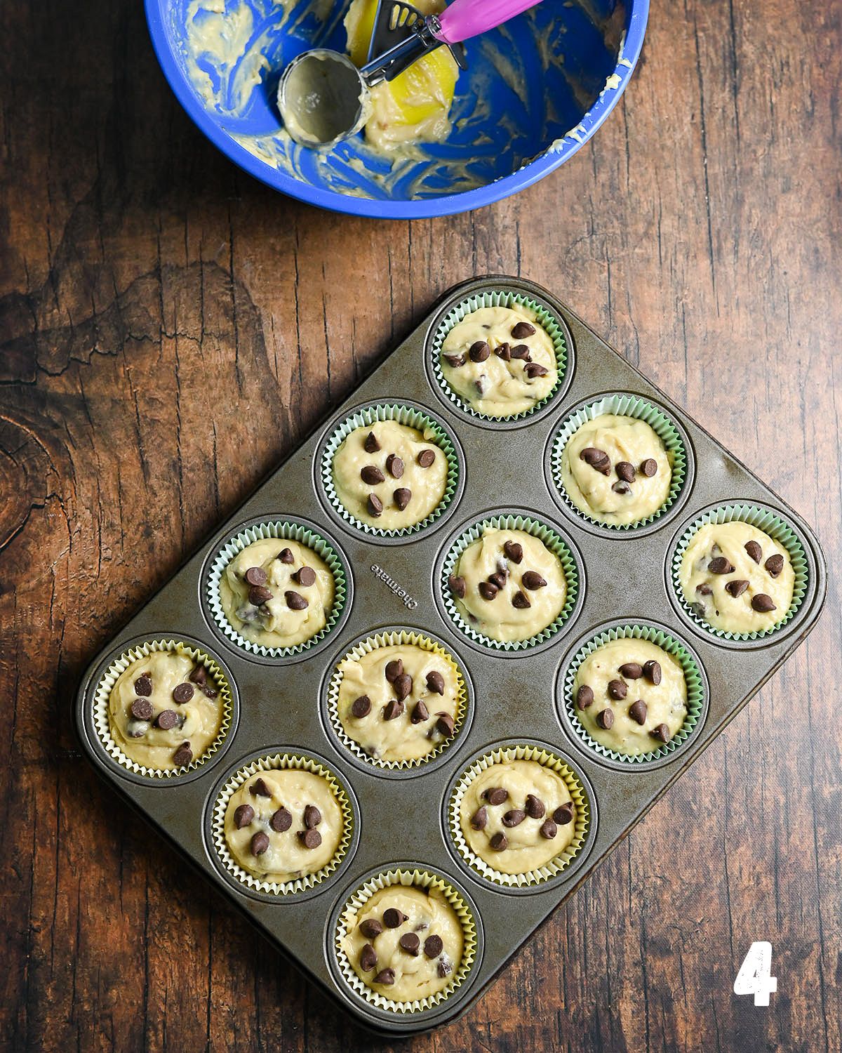 A muffin tin full of batter ready to be baked.