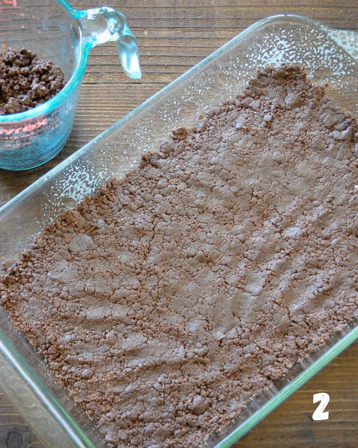 Chocolate cookie base pressed into baking dish.