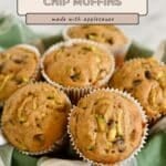 Zucchini chocolate chip muffins in paper liners rest on a green checkered cloth, showcasing a tasty twist—these zucchini bread muffins with applesauce are moist and delicious.