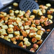 A baking sheet with golden brown roasted potatoes.