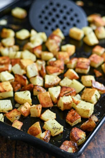 A baking sheet with golden brown roasted potatoes.
