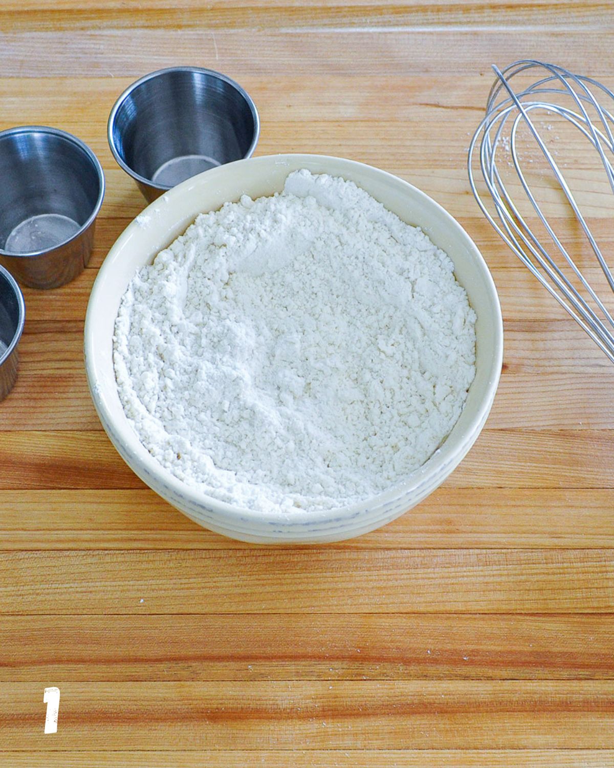 Flour in a small cream color bowl. 