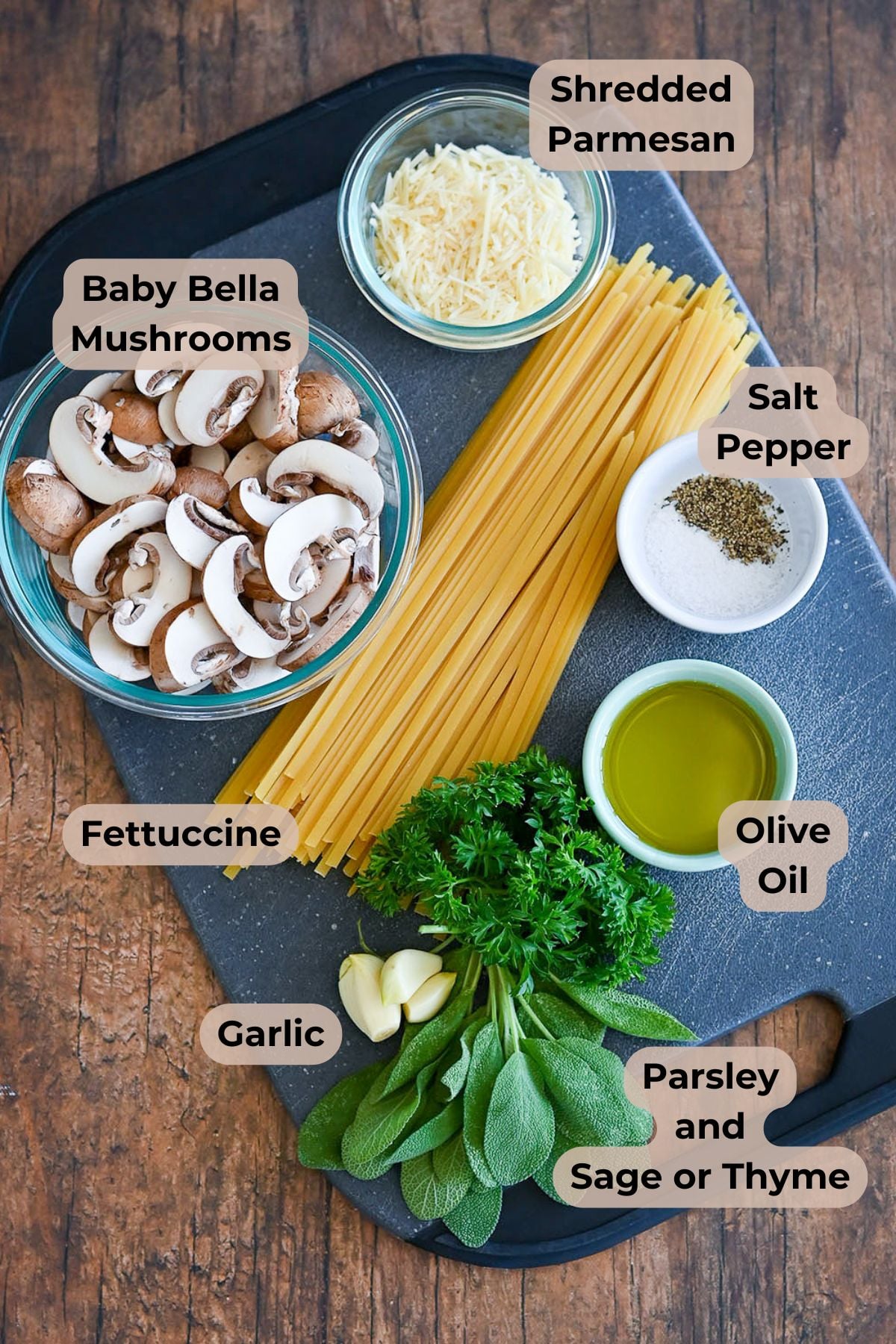 Ingredients for Pasta with Baby Bella Mushrooms: fettuccine, Baby Bella mushrooms, shredded parmesan, olive oil, garlic, herbs, salt, and pepper.