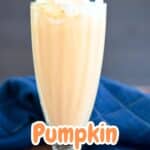 Pumpkin milkshake with whipped cream and a straw.