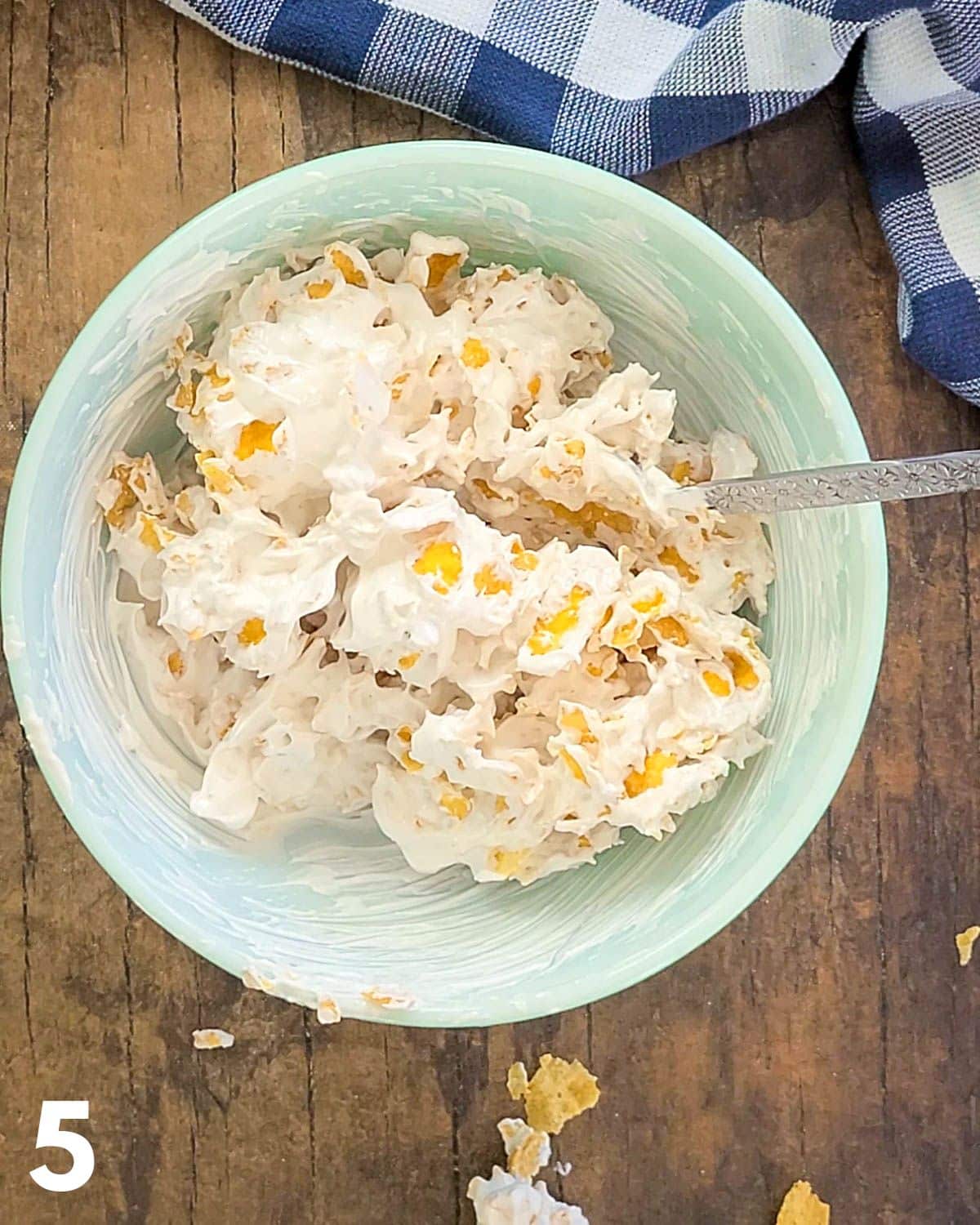 Meringue cookies batter with corn flakes in a bowl.