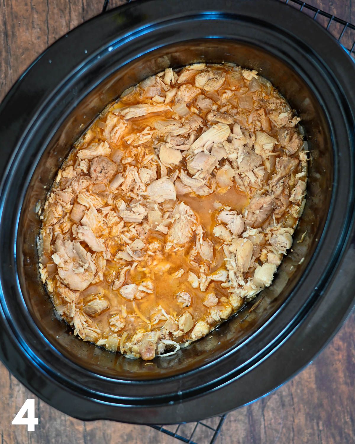 Cooked chicken in a crock pot.