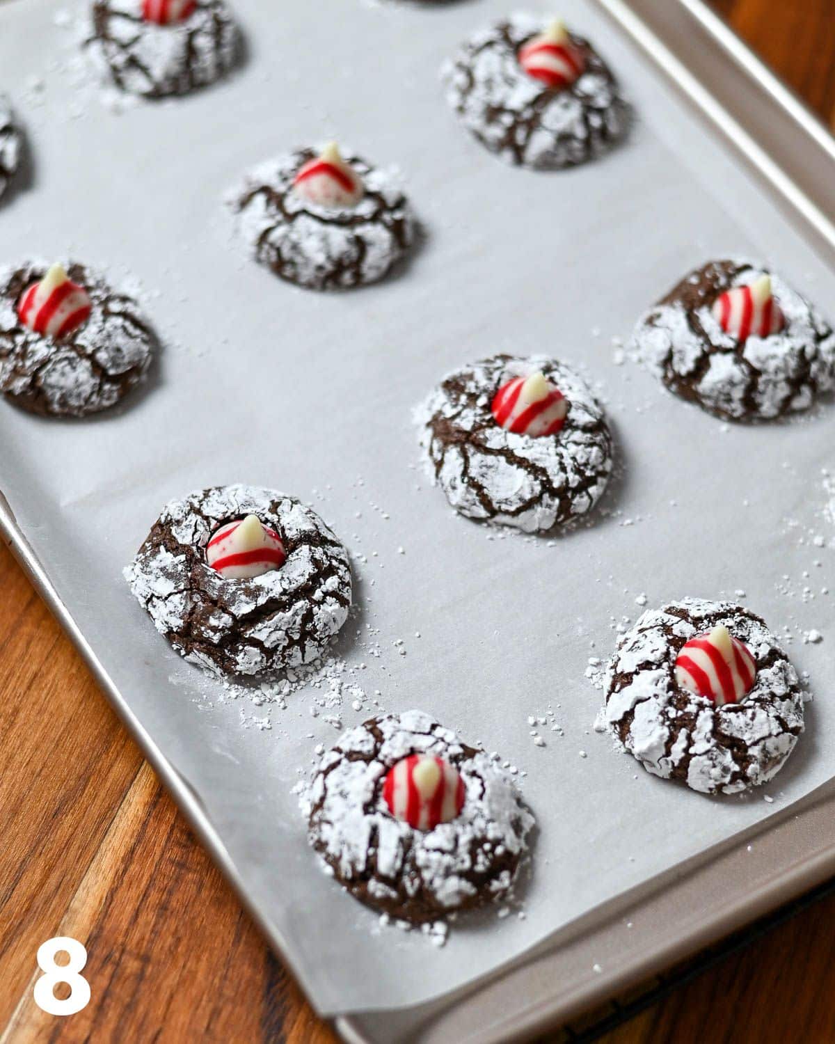 Candy cane Hershey Kisses pressed into chocolate crinkle cookies. 