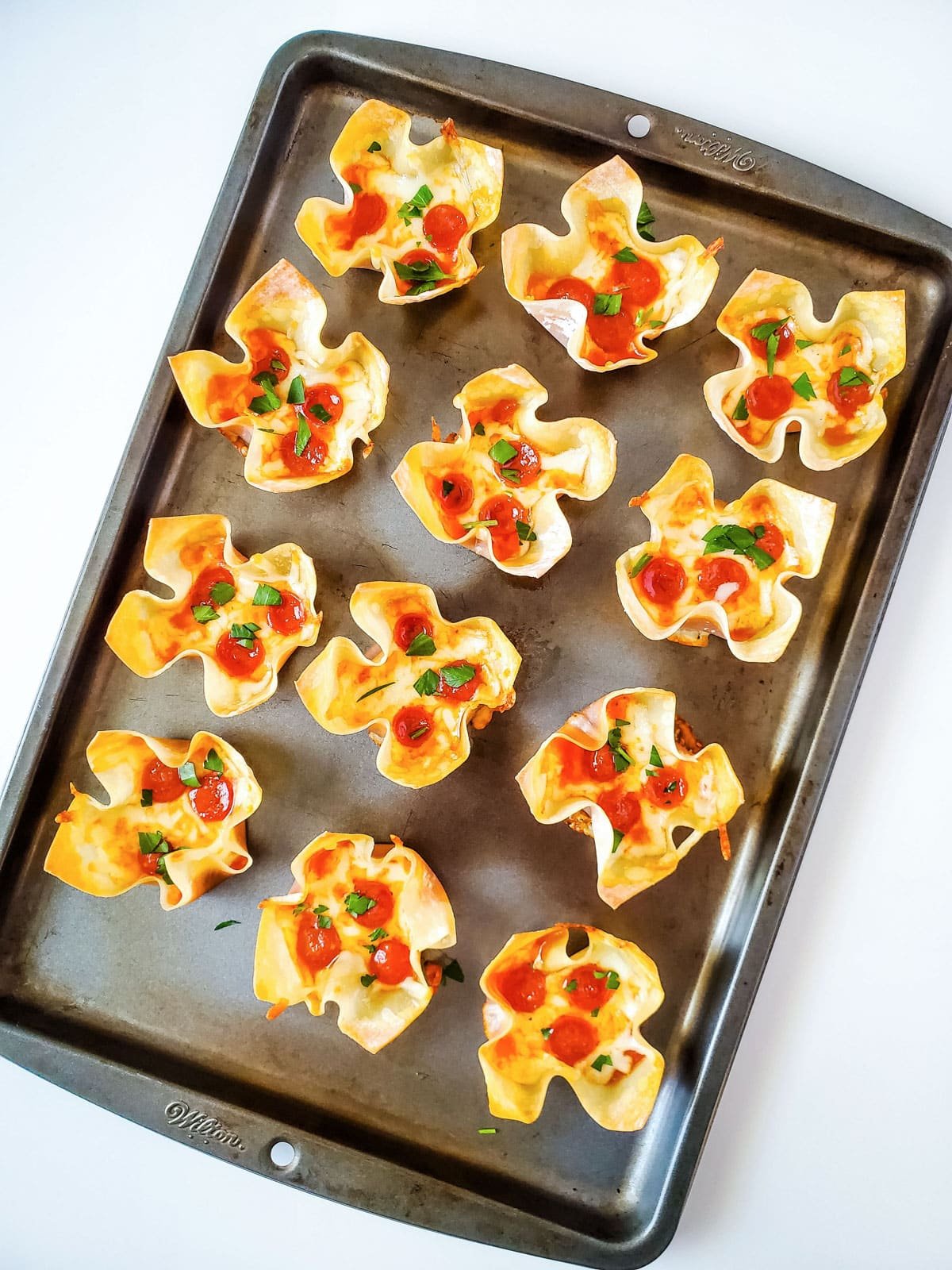 Baked wonton cups on a cookie sheet. 