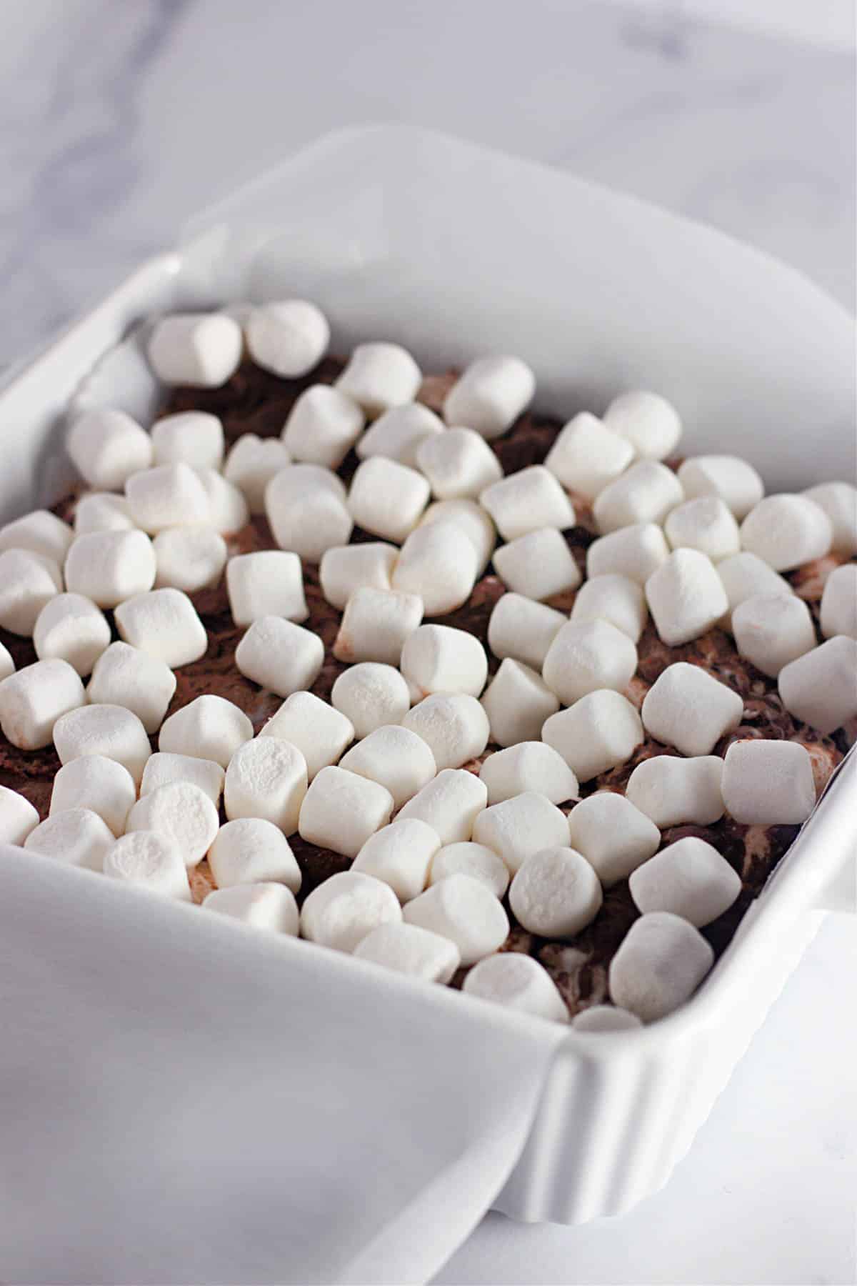 Mini marshmallows sprinkled over rocky road bars. 
