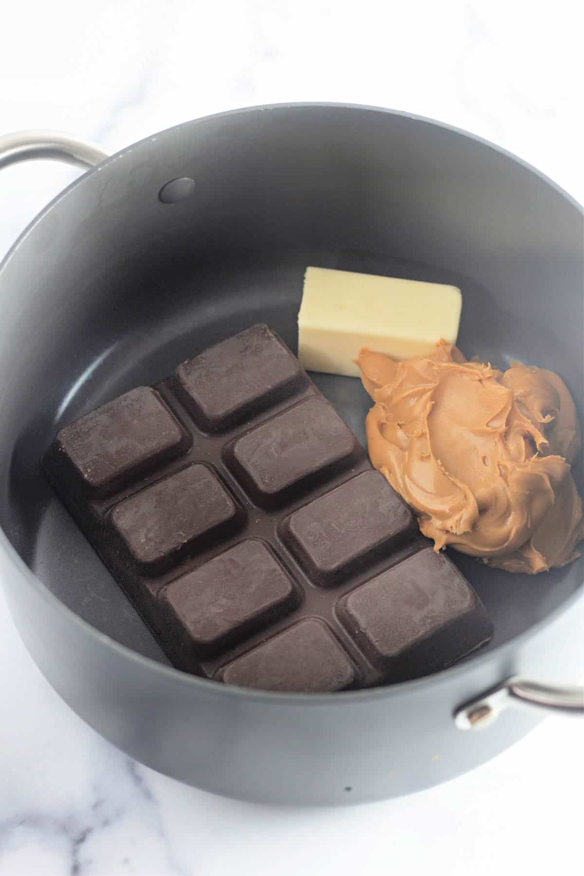 Butter, peanut butter, and chocolate in a saucepan. 