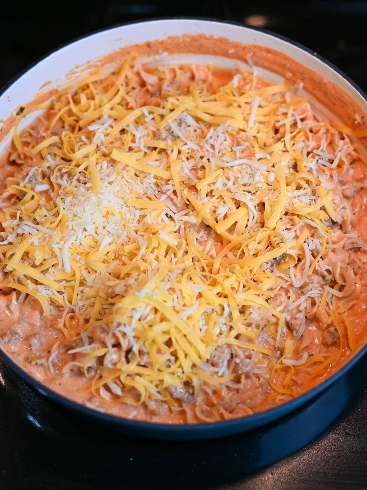 Cheese added to the top of a skillet lasagna. 