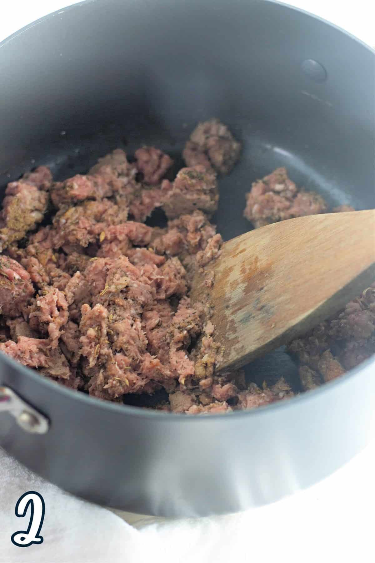 Ground turkey and spices cooking in a large pot.
