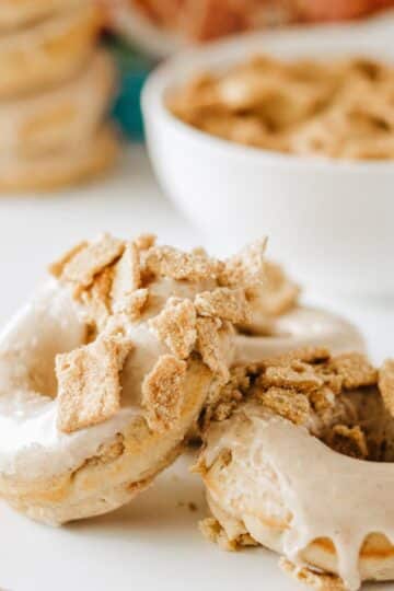 Cinnamon Toast Crunch Cereal Donuts stacked on a counter.