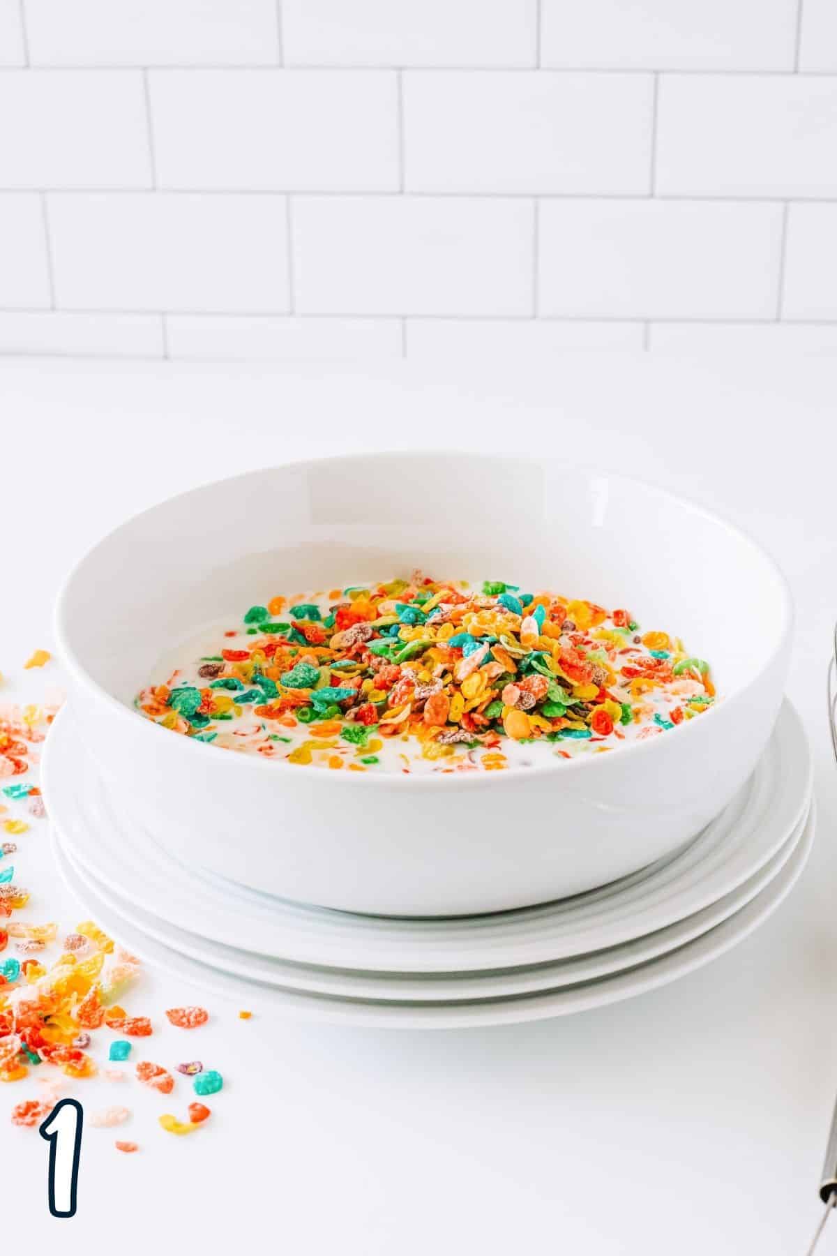 Fruity pebbles cereal and buttermilk in a white bowl. 