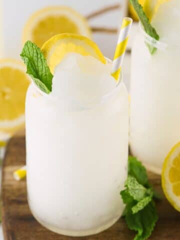 A lemonade slushie in a clear glass.