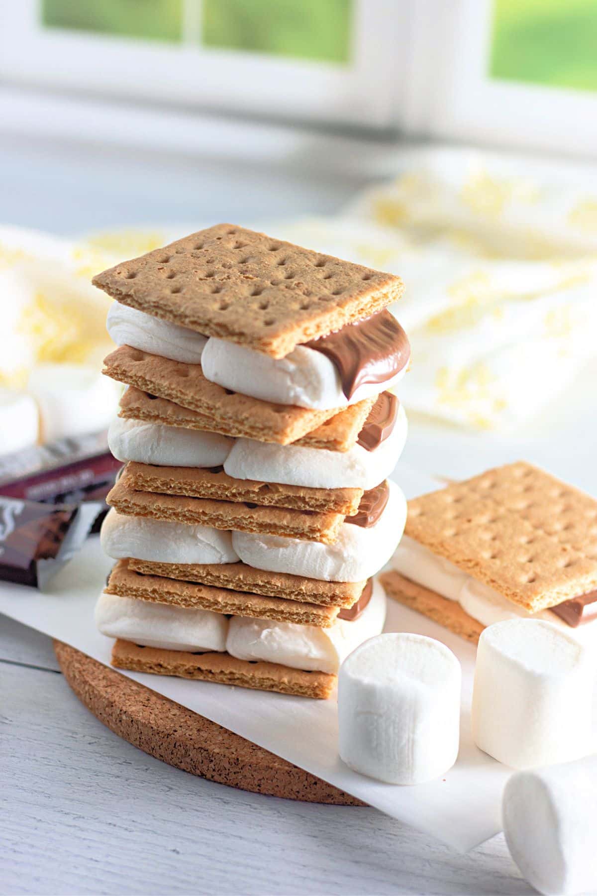 A stack of smores on parchment paper. 