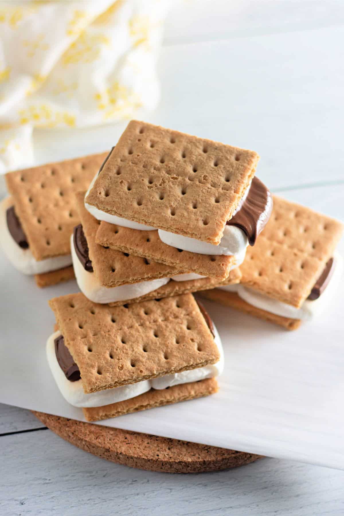 A stack of smores on parchment paper.