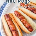 Bacon-wrapped hot dogs in buns on a white plate, text reads "Delicious Bacon Wrapped Hot Dogs in the Air Fryer!.