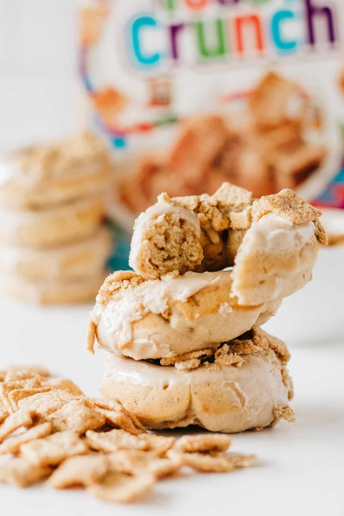 A stack of baked donuts made with cinnamon toast crunch cereal. 