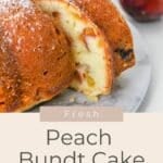 Sliced Peach Bundt Cake on a marble plate with a fresh peach in the background, text overlay promoting this irresistible dessert.