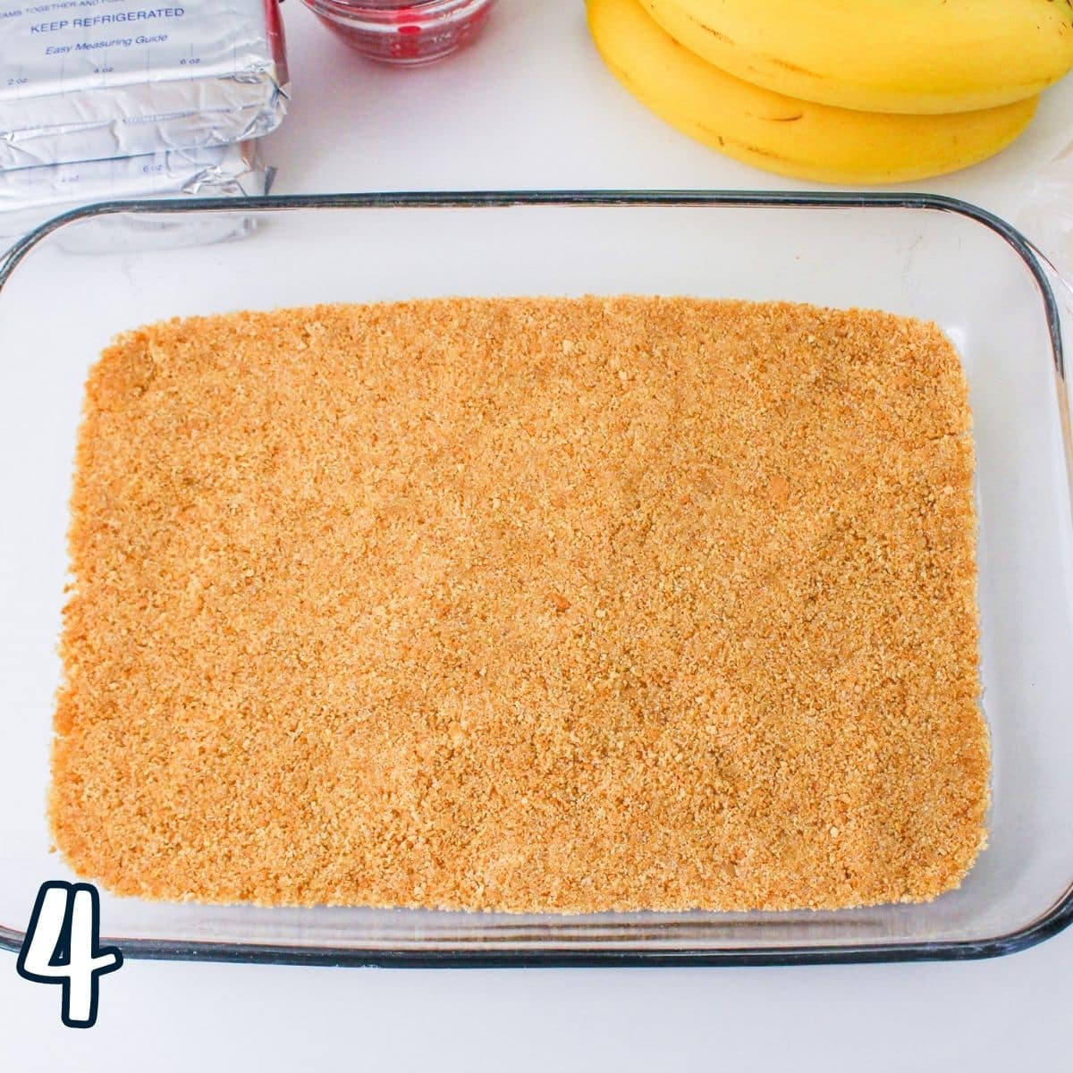 A graham cracker crust pressed into a 9 by 13 baking dish. 