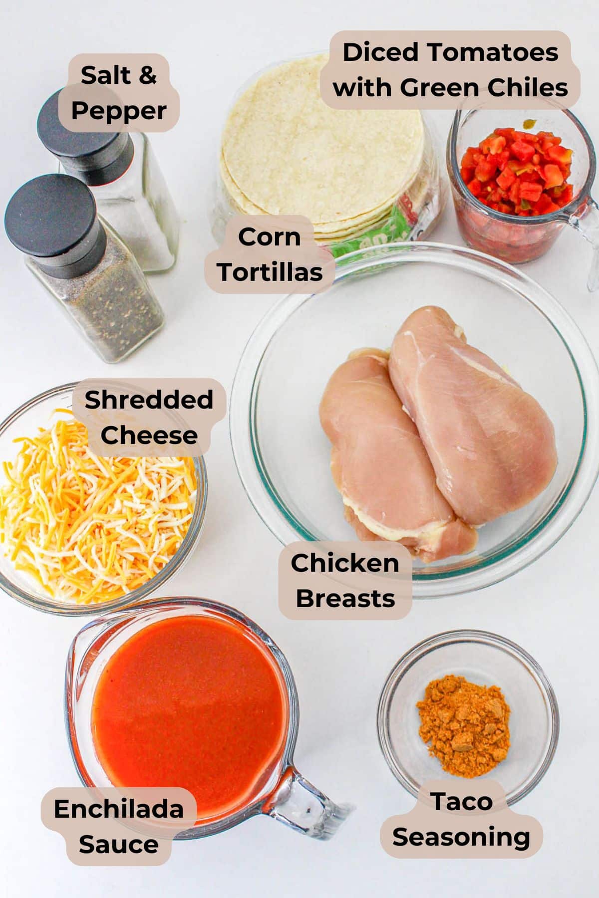 Ingredients for Slow Cooker Chicken Enchiladas: chicken breasts, corn tortillas, cheese, enchilada sauce, taco seasoning, and tomatoes.