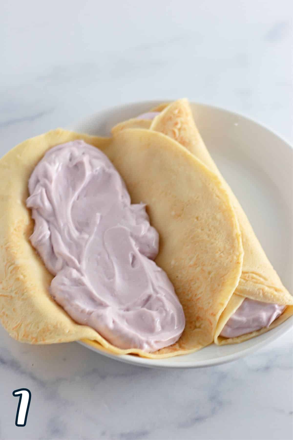 A blueberry cream cheese and yogurt filling spread inside a crepe. 
