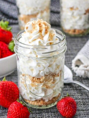 Cheesecake mousse topped with graham cracker crumbs served in a mason jar.